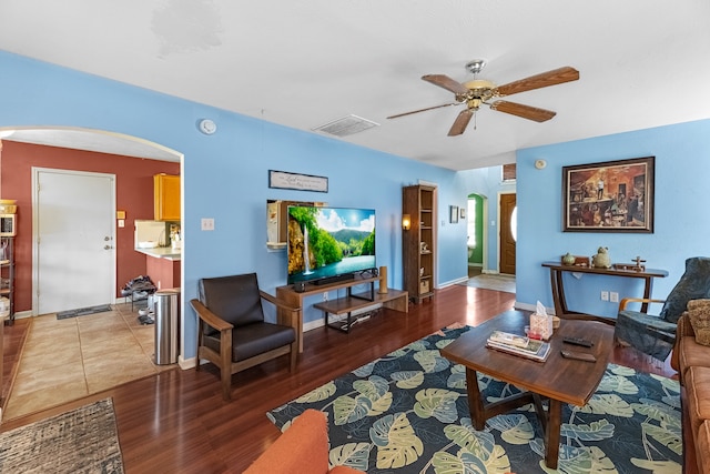 living room featuring wood-type flooring and ceiling fan