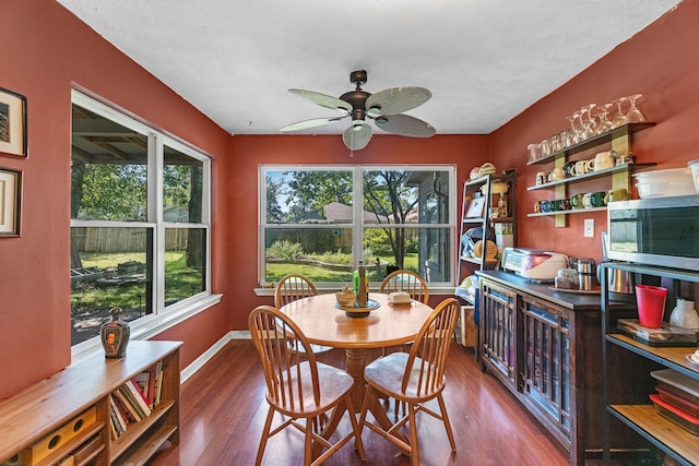 dining space with wood-type flooring and ceiling fan