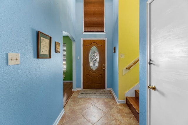 doorway with light tile patterned flooring