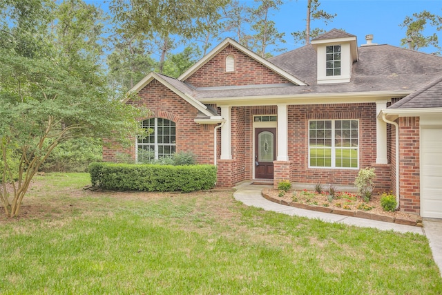 view of front of property featuring a garage and a front lawn