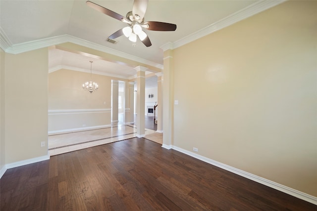 spare room with dark hardwood / wood-style floors, ceiling fan with notable chandelier, lofted ceiling, decorative columns, and ornamental molding