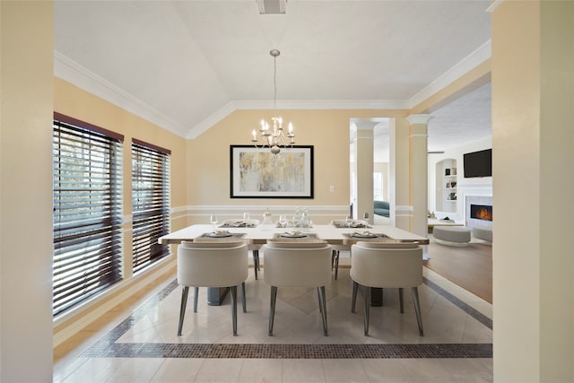 dining space featuring lofted ceiling, light tile patterned floors, a chandelier, crown molding, and ornate columns