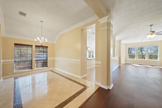 unfurnished room with a healthy amount of sunlight, ceiling fan with notable chandelier, light hardwood / wood-style floors, and vaulted ceiling