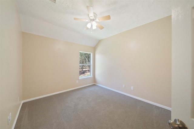 unfurnished room featuring ceiling fan, carpet floors, vaulted ceiling, and a textured ceiling