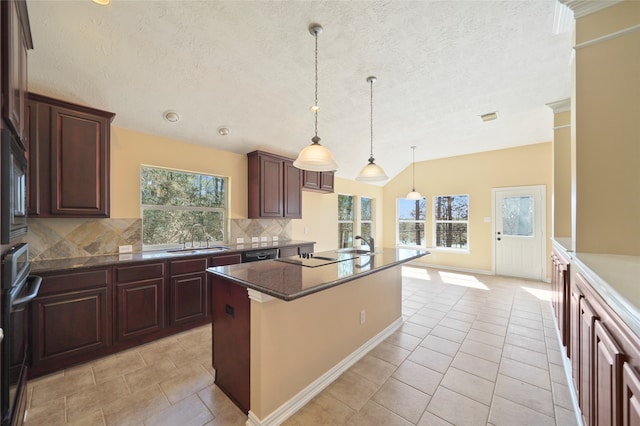 kitchen with pendant lighting, a textured ceiling, a kitchen island, backsplash, and light tile patterned floors