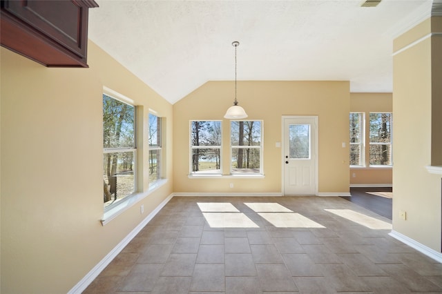 interior space with tile patterned flooring and vaulted ceiling