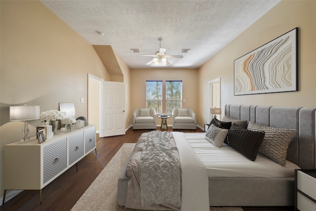 bedroom featuring vaulted ceiling, ceiling fan, dark hardwood / wood-style floors, and a textured ceiling