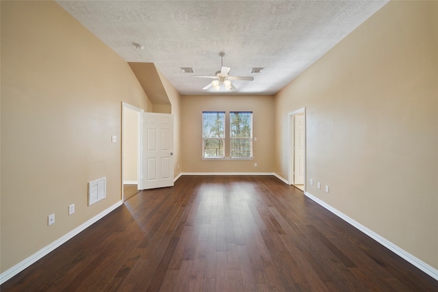 spare room with a textured ceiling, dark hardwood / wood-style floors, and ceiling fan