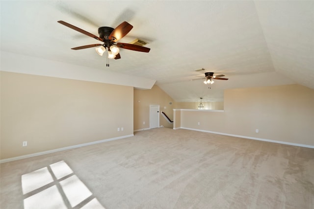 unfurnished living room with vaulted ceiling, light carpet, and ceiling fan