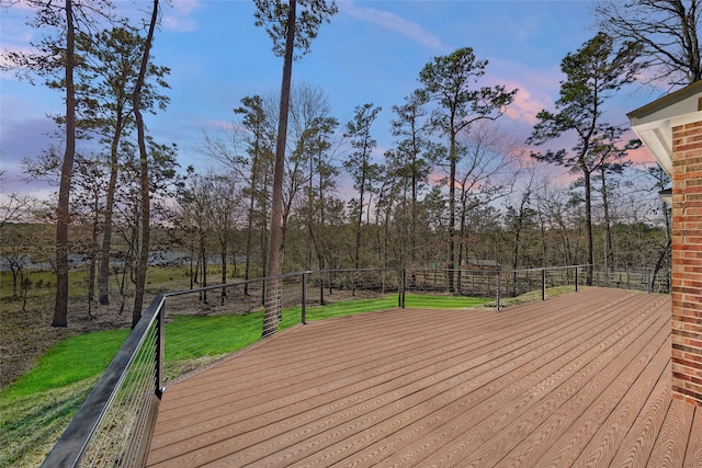 deck at dusk with a lawn