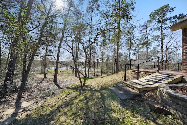 view of yard featuring a deck with water view