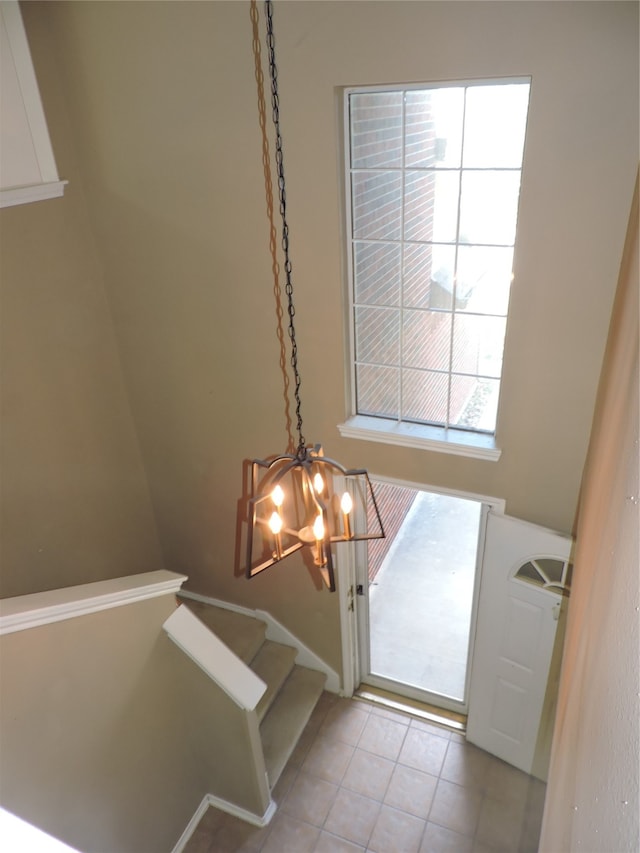 entrance foyer featuring an inviting chandelier and light tile patterned floors