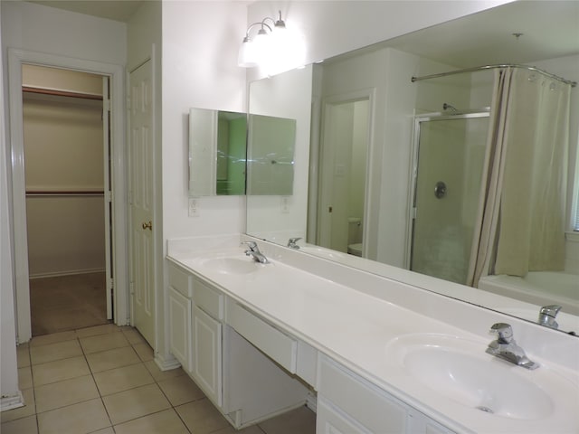 bathroom with tile patterned floors, walk in shower, vanity, and toilet