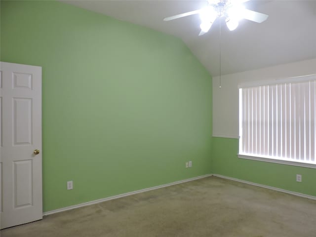 spare room with ceiling fan, light colored carpet, and lofted ceiling