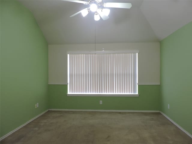 carpeted empty room featuring vaulted ceiling and ceiling fan