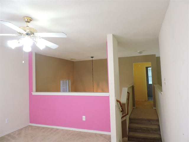 staircase featuring carpet and ceiling fan