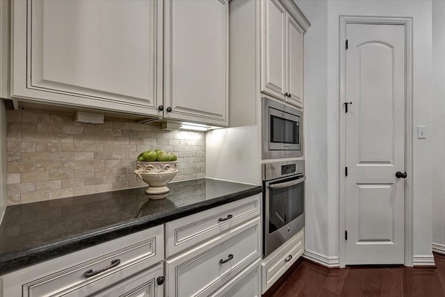 15026 Blossom Bay Dr, Houston, TX 77059 - kitchen featuring stainless steel appliances, dark wood-style floors, tasteful backsplash, and baseboards