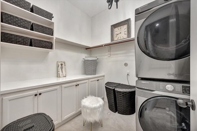 15026 Blossom Bay Dr, Houston, TX 77059 - washroom with light tile patterned flooring and stacked washing maching and dryer