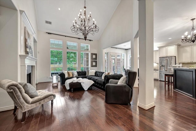 15026 Blossom Bay Dr, Houston, TX 77059 - living room with a healthy amount of sunlight, visible vents, dark wood-type flooring, and an inviting chandelier