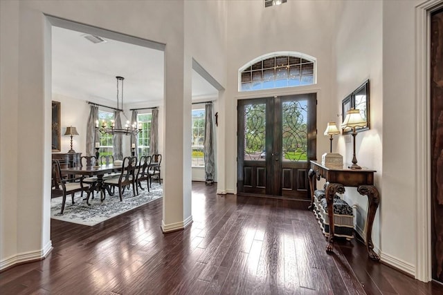 15026 Blossom Bay Dr, Houston, TX 77059 - foyer with baseboards, a high ceiling, wood finished floors, and a chandelier