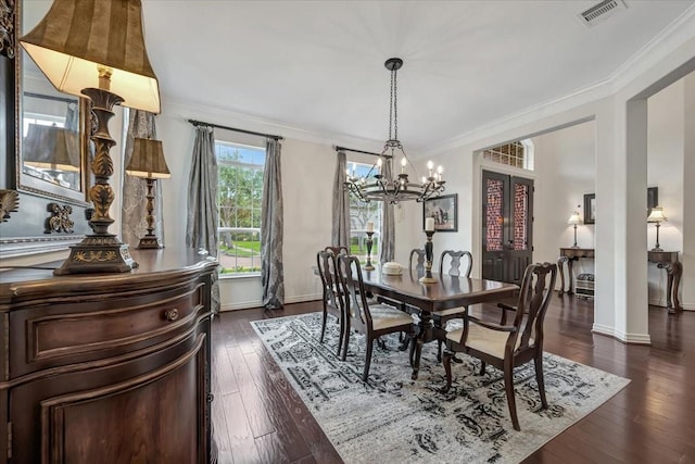 15026 Blossom Bay Dr, Houston, TX 77059 - dining room featuring dark wood-style flooring, visible vents, crown molding, baseboards, and an inviting chandelier