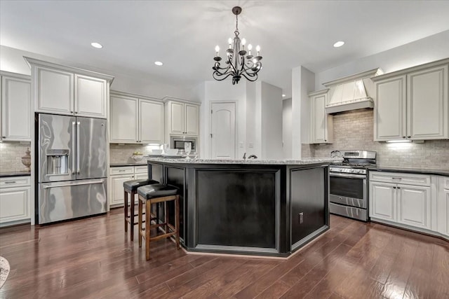 15026 Blossom Bay Dr, Houston, TX 77059 - kitchen featuring a center island, custom range hood, dark wood-style flooring, and stainless steel appliances