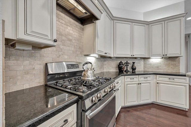 15026 Blossom Bay Dr, Houston, TX 77059 - kitchen featuring stainless steel gas stove, backsplash, dark wood-style floors, custom exhaust hood, and dark stone counters