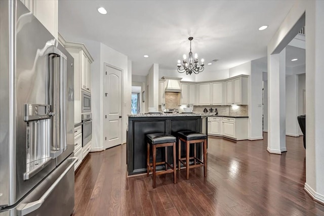 15026 Blossom Bay Dr, Houston, TX 77059 - kitchen featuring stainless steel appliances, dark wood-type flooring, backsplash, a kitchen island, and a notable chandelier