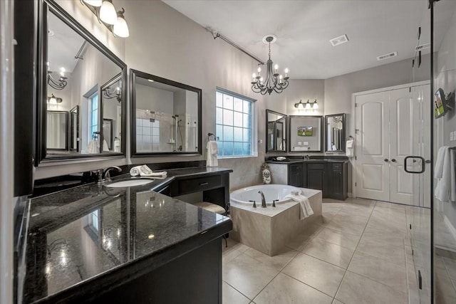 15026 Blossom Bay Dr, Houston, TX 77059 - full bath with visible vents, tile patterned floors, two vanities, a garden tub, and a notable chandelier