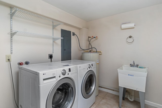 clothes washing area featuring light tile patterned floors, electric panel, washing machine and clothes dryer, and electric water heater