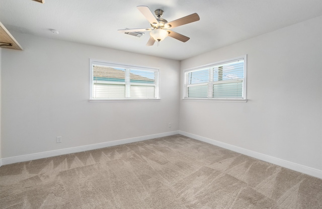 carpeted empty room featuring ceiling fan