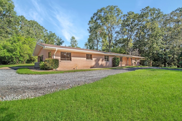 ranch-style house featuring central AC and a front yard