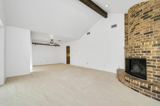 unfurnished living room with vaulted ceiling with beams, ceiling fan, light colored carpet, and a brick fireplace