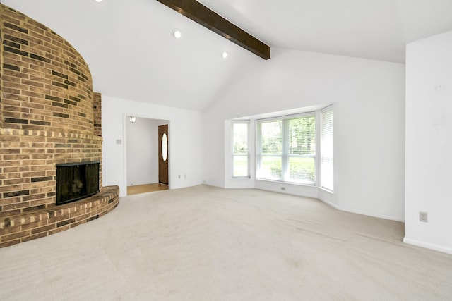 unfurnished living room featuring lofted ceiling with beams, a fireplace, and light carpet