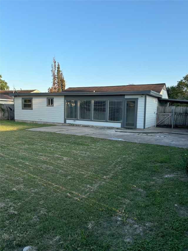 back of house with a patio area and a yard