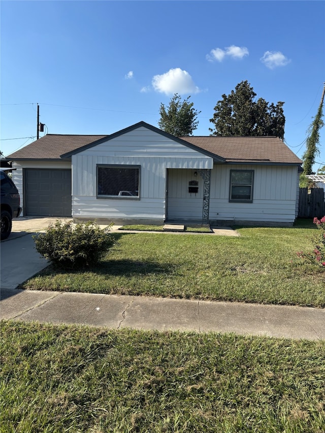 ranch-style home with a front yard and a garage