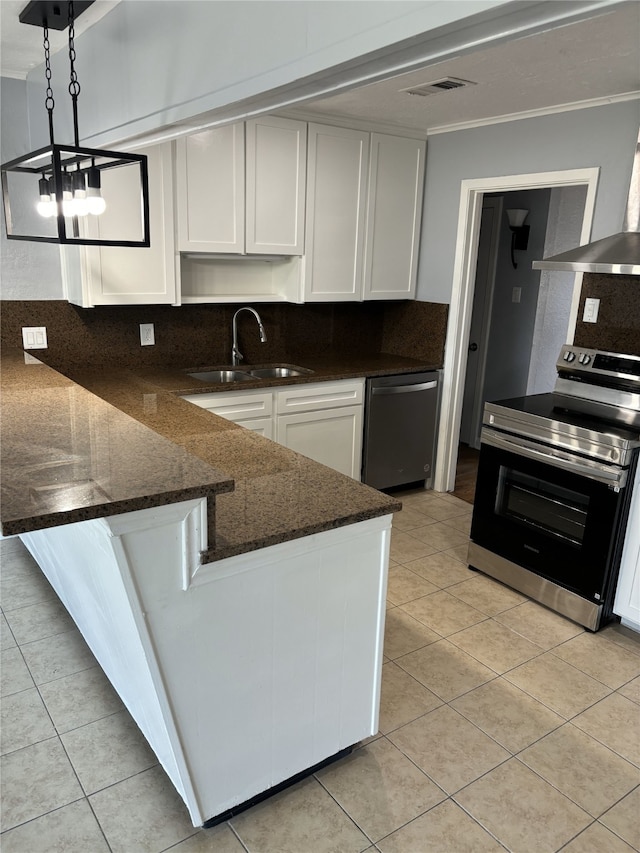 kitchen featuring appliances with stainless steel finishes, white cabinetry, pendant lighting, sink, and a notable chandelier