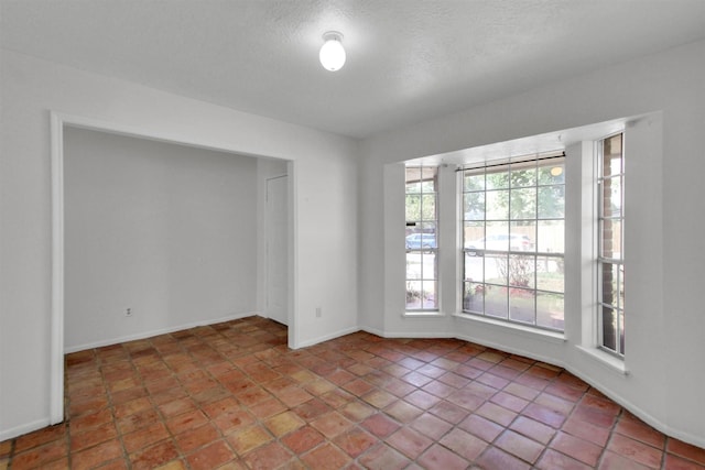 spare room with a textured ceiling