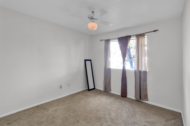 empty room with carpet flooring and ceiling fan