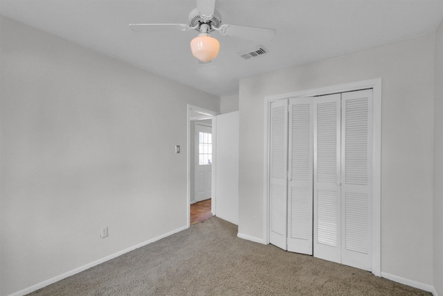 unfurnished bedroom featuring carpet, ceiling fan, and a closet