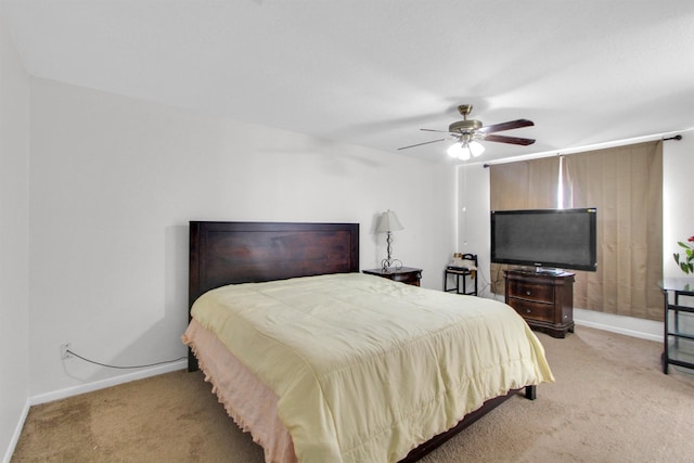 bedroom with ceiling fan and light carpet