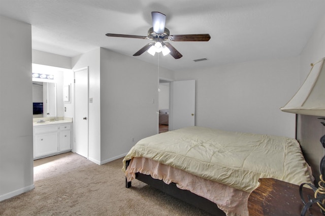 carpeted bedroom featuring connected bathroom and ceiling fan