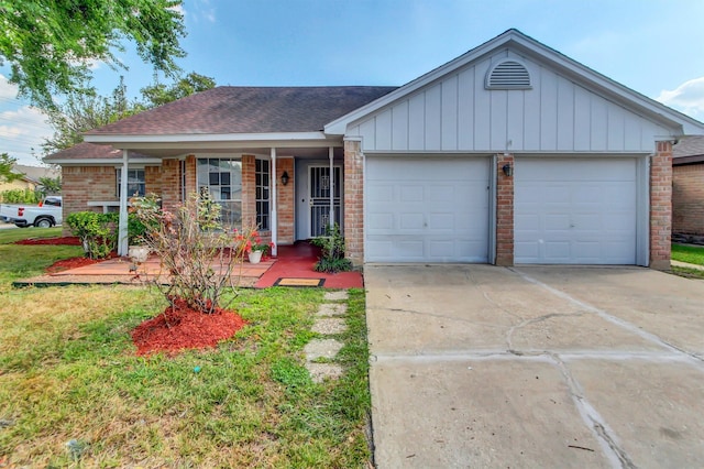 ranch-style home with covered porch, a garage, and a front lawn