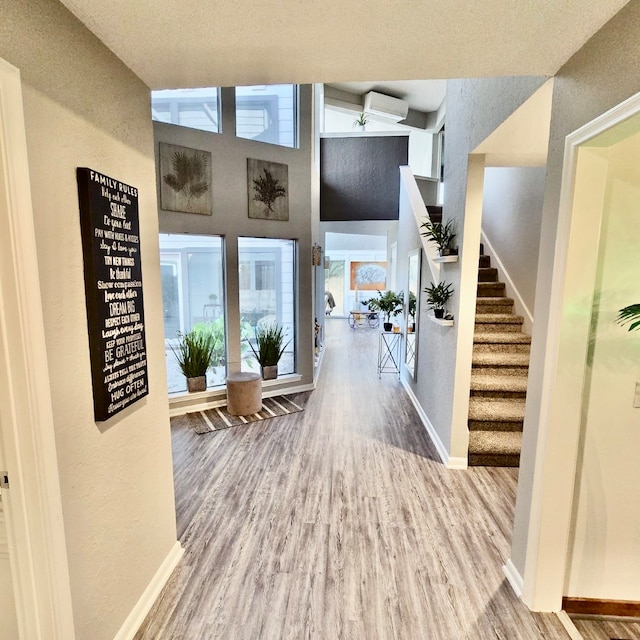 hall featuring hardwood / wood-style floors and high vaulted ceiling