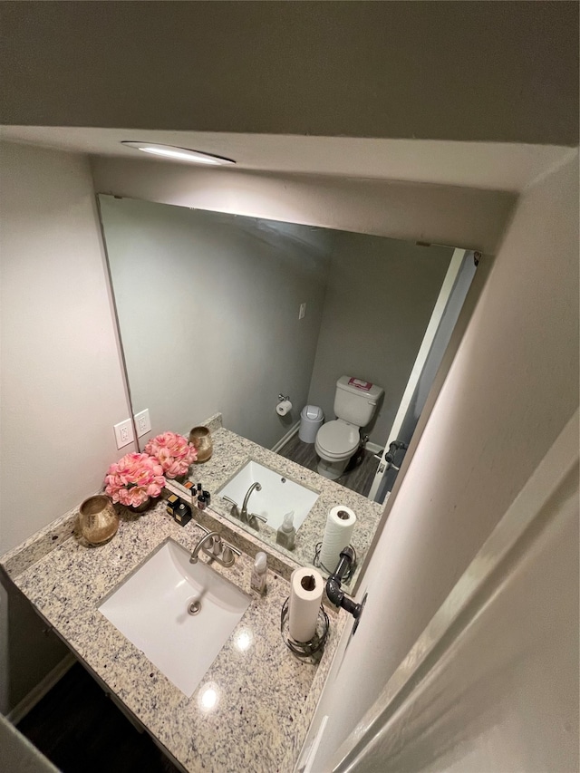 bathroom featuring vanity and toilet