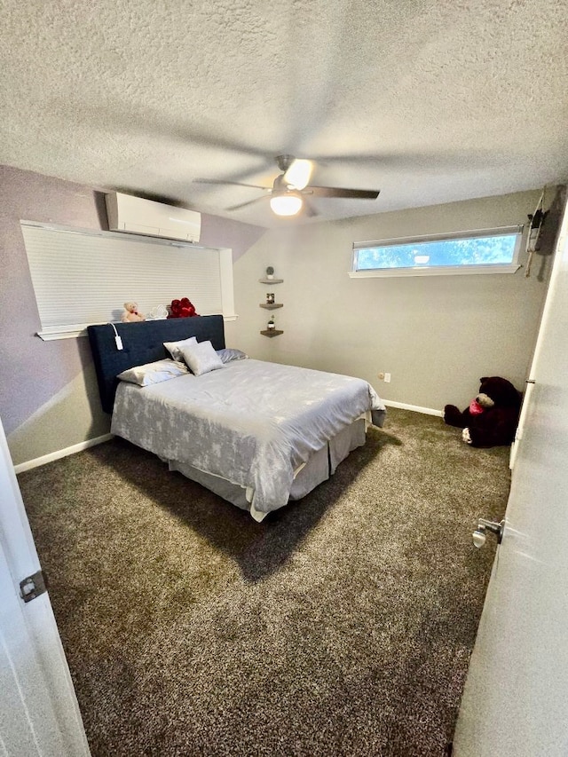 carpeted bedroom with a textured ceiling, ceiling fan, and a wall mounted AC