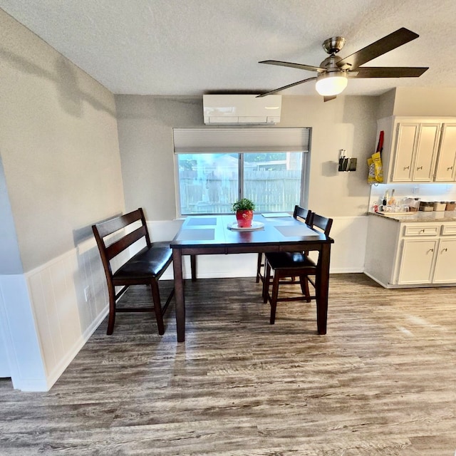 dining room featuring ceiling fan, a textured ceiling, and light hardwood / wood-style floors