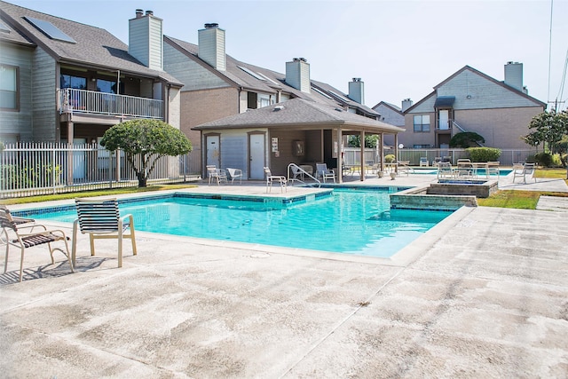 view of pool featuring an in ground hot tub and a patio area