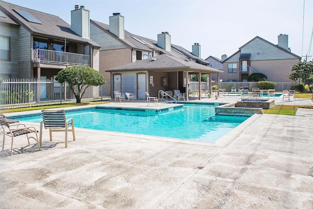 8235 Sands Point Dr Unit 156, Houston, TX 77036 - community pool featuring a hot tub, a patio area, and a fenced backyard