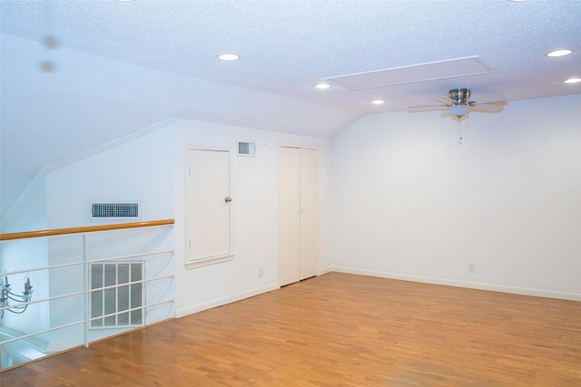 8235 Sands Point Dr Unit 156, Houston, TX 77036 - bonus room featuring attic access, wood finished floors, a textured ceiling, recessed lighting, and lofted ceiling